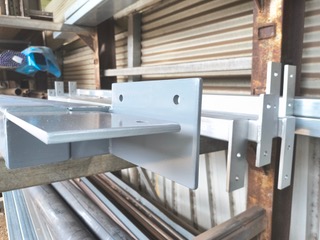 Close-up of custom-fabricated steel brackets ready for pickup at Marshall Steel